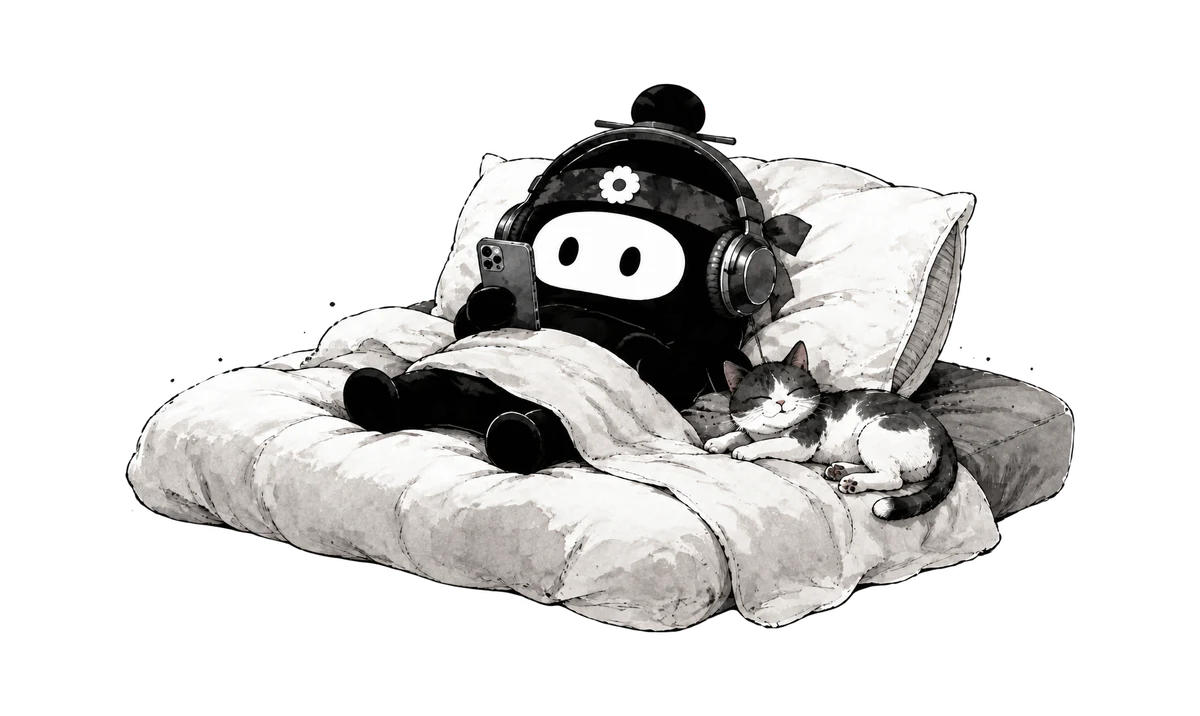 Dubu lounges under the blankets with headphones and a phone while a cat naps beside him.